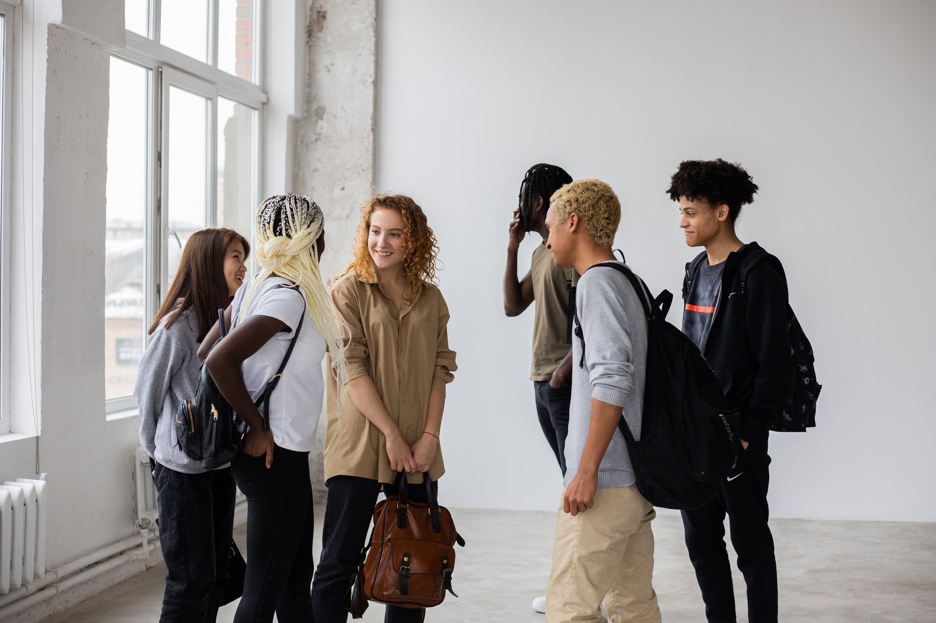 diverse classmates talking to each other after studies